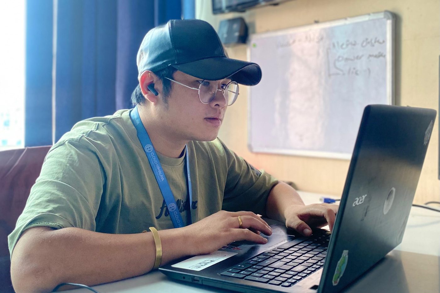Luchhen Lama working at a laptop in the office